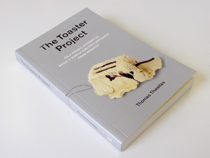 Photo of the Toaster Project book which shows a molten toster that looks like it came out of a H.P. Lovecraft novel