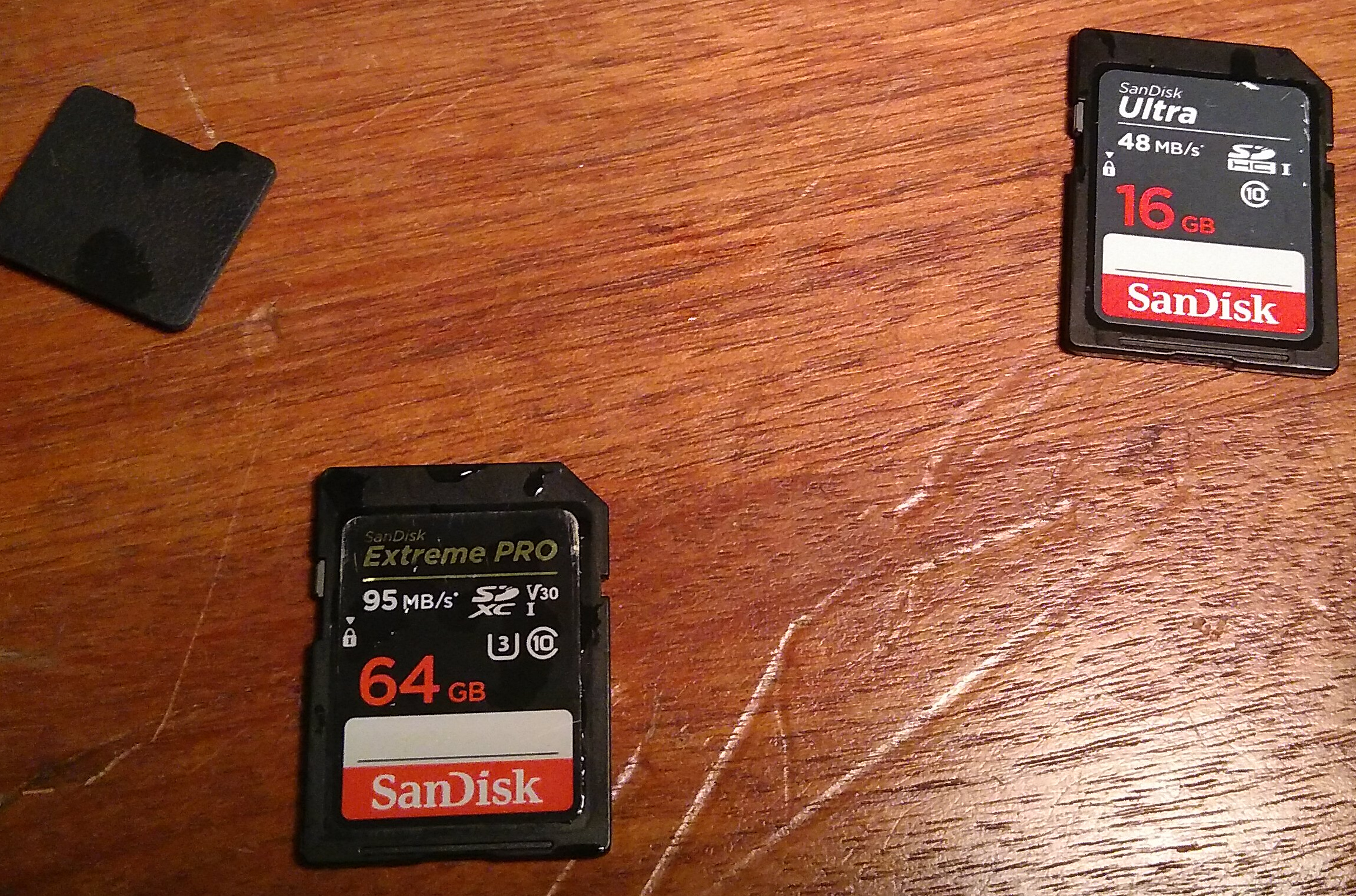 Two Sandisk memory cards with
water droplets on them